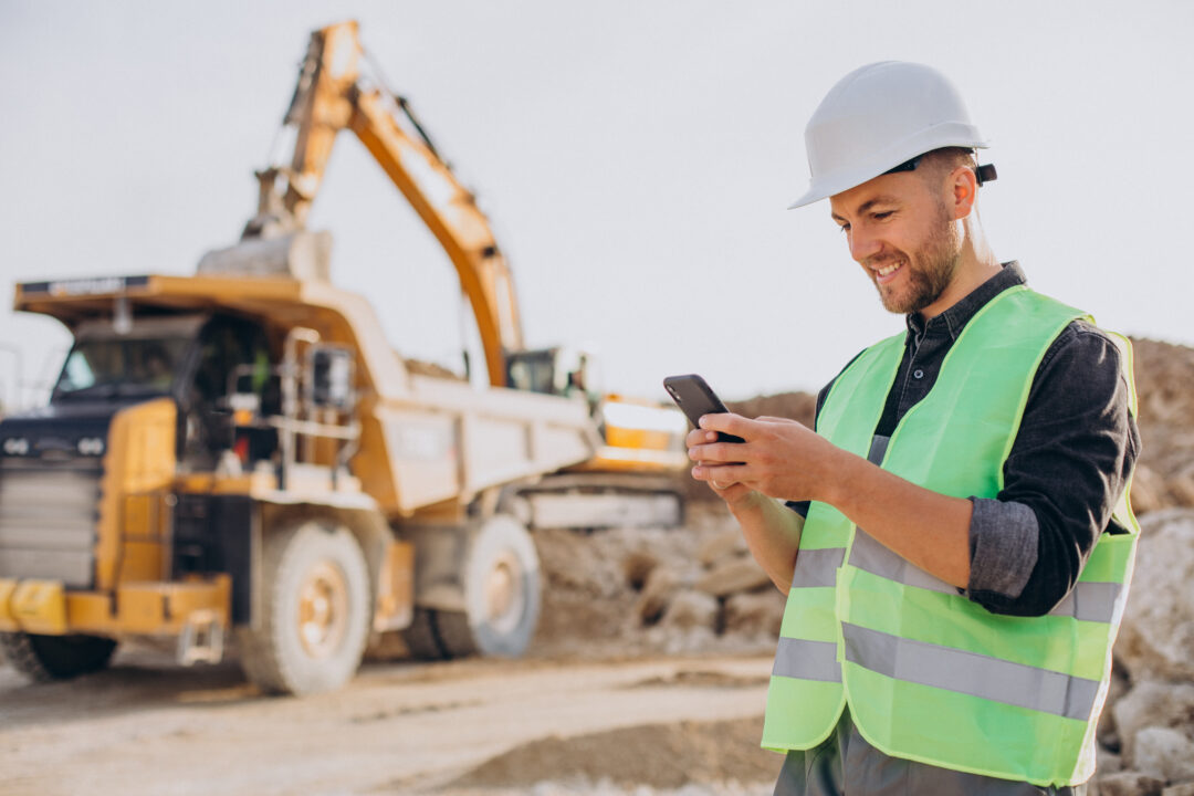 male worker with bulldozer sand quarry